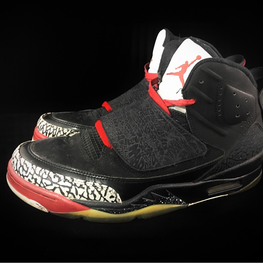 Air Jordans (used) Black with stripe print on front